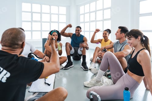 Preview: Fitness class listening to their trainer explaining exercises