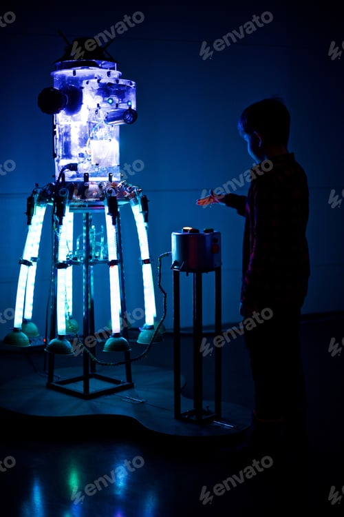 Preview: Young boy is pushing the button of the glowing robot