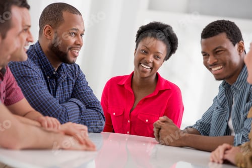 Preview: An office interior flooded with light. A group of four people, two men and two women.