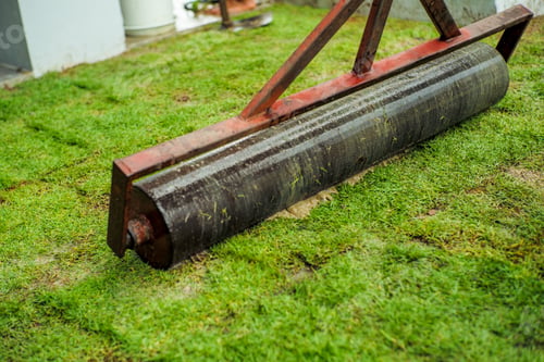 Preview: Selective focus on the middle of the heavy steel drum for pressing the lawn field