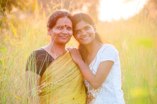 Preview: Portrait of happy mother and daughter in meadow at sunset. Smart Blurred photo
