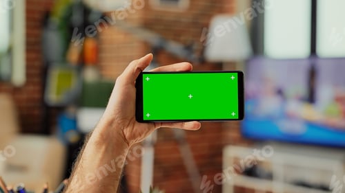 Preview: Young manager holding telephone with horizontal greenscreen template