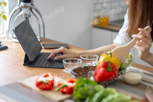 Preview: asian japanese woman in kitchen at home, web tutor cooking class cutting vegetables, cooking,