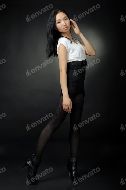 Preview: Asian Girl In T-Shirt And Shorts On Black