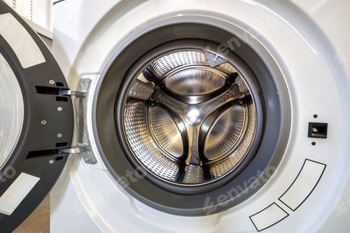 Preview: Close-up detail of modern washing machine interior with open door interior. Silver shiny stainless