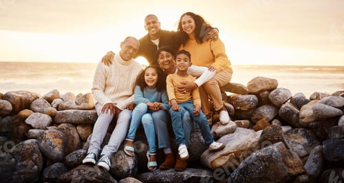 Preview: Black family, parents and children in beach portrait with excited face, sitting and rocks with gran