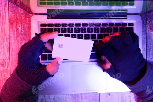 Preview: hacker hand stealing data from credit card