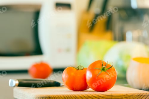 Preview: Fresh Tomatoes on a Cutting Board in Kitchen