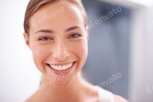 Preview: Youthful beauty. A young woman smiling at the camera - closeup.