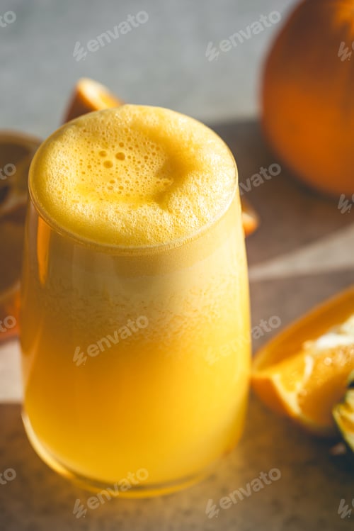 Preview: Close-up, glass of orange juice on a blurred background with oranges.