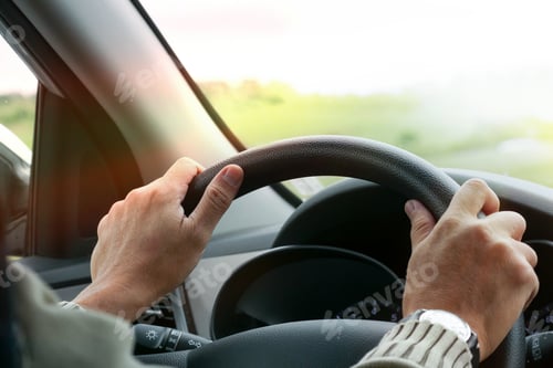Preview: Hand of man driving car