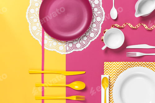 Preview: Colorful dishes on a yellow rose table. Stylish arrangement.