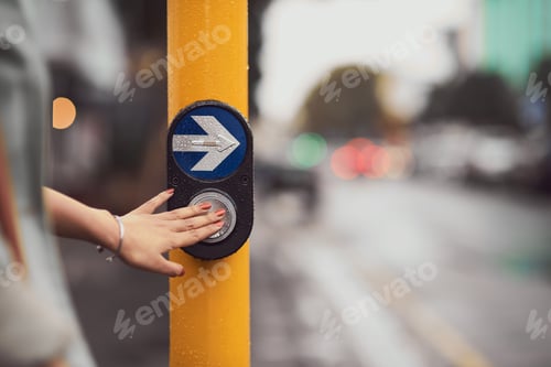 Preview: Push to cross safely. Closeup shot of a woman pressing a button at a cross walk.