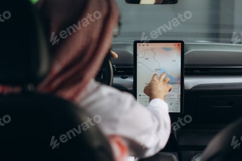 Preview: Person navigating middle east map in car on screen
