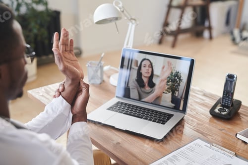 Preview: Male Doctor Working With Patient Online