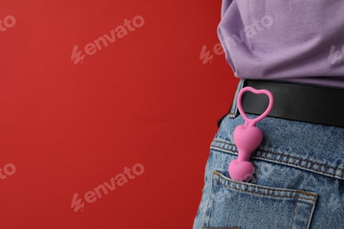 Preview: Anal chain in the pocket of jeans on a red background
