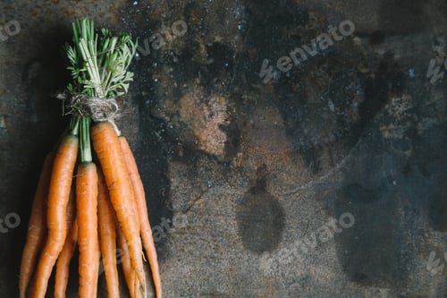 Preview: Bunch of fresh garden carrots on rusty background