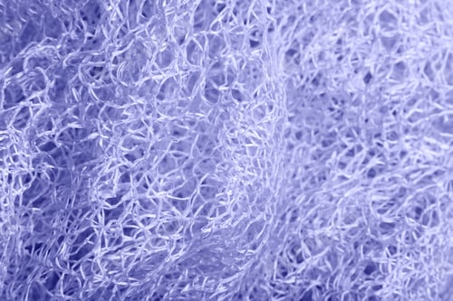 Preview: Close up of purple knitted textured background.