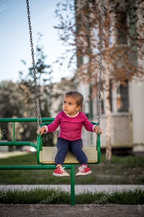 Preview: beautiful little girl playing on the Playground