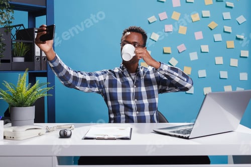 Preview: Business development agency employee taking picture of himself with smartphone device