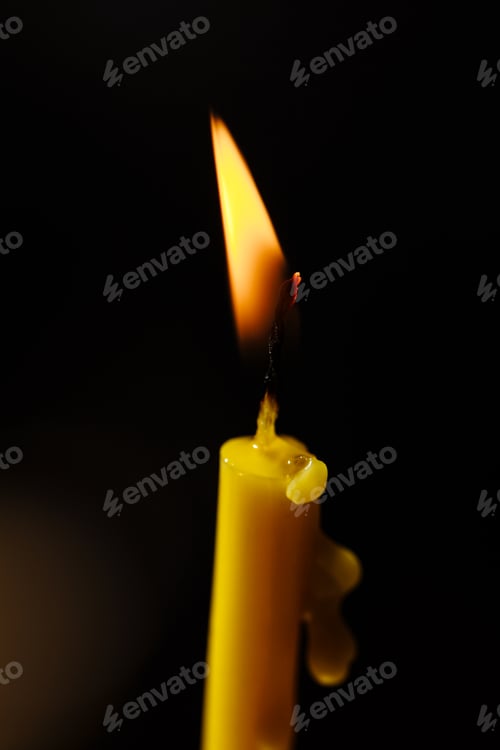 Preview: Burning candle on black background. Candle light. The flame of candle light.