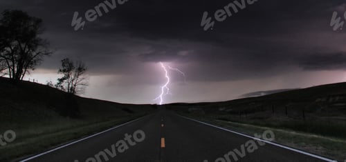 Preview: A single cloud-to-ground bolt lands at the end of a rural road, Lexington, Nebraska, USA