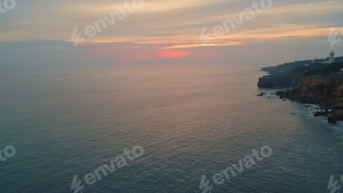 Preview: Atmospheric sunset ocean view with rocky coastline. Aerial of tranquil marine