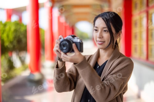 Preview: Travel woman use digital camera to take photo in chinese temple
