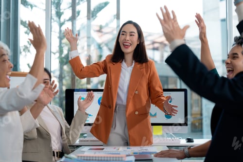Preview: Business team celebrating good news and corporate success in the office