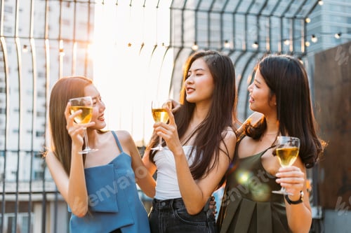 Preview: Group of happy Asian girl friends celebrating party with champagne toasting drinks