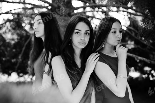 Preview: Three teenagers girl in blue and red dresses posed outdoor.