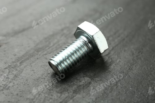 Preview: One metal bolt on black table, closeup