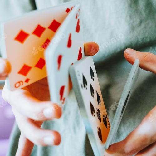 Preview: Closeup shot of a person holding cards - street magic concept