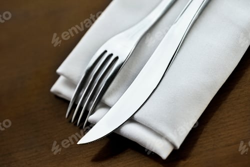 Preview: Fork and knife and napkin on a table set