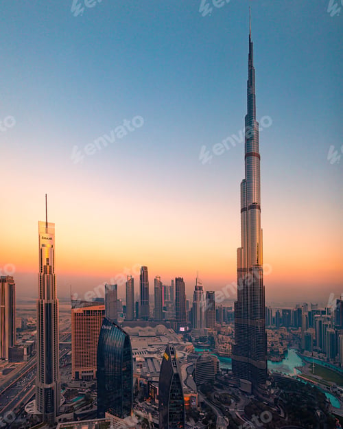Preview: Aerial view of Burj Khalifa and Dubai skyline at sunset.