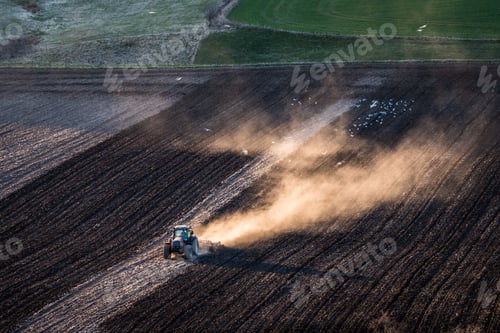 Preview: Birds-eye view shot of a mini combine harvester in a field