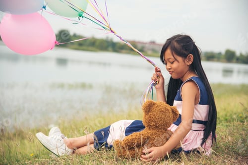Preview: Happy Child hug teddy bear in green park playground. Teddy bear best friend for little kids