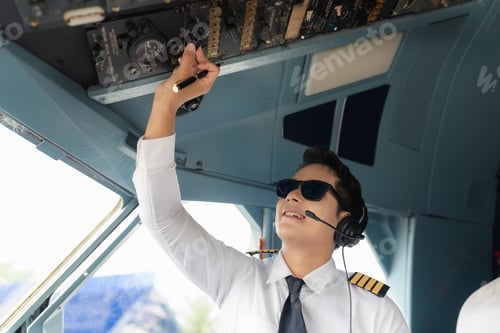 Preview: Portrait of a trained airplane captain in uniform preparing to fly in a simulator cockpit.
