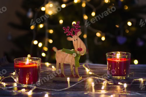 Preview: Christmas still life burning candles and wooden deer toy
