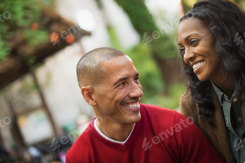 Vista previa: A man and a woman,a couple. Looking at each other. Outdoors.