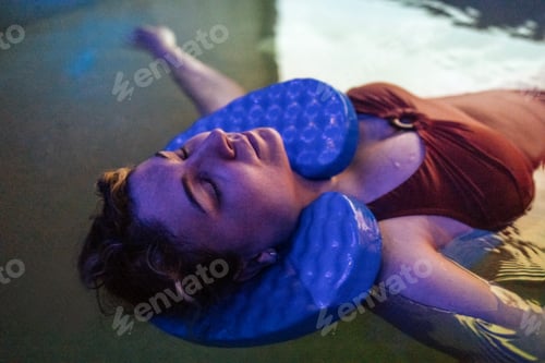 Preview: A young woman in a red swimsuit is swimming in the pool.