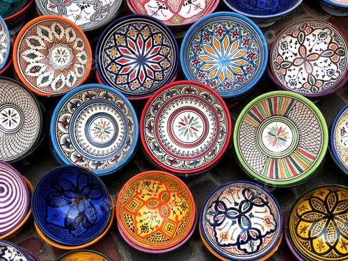 Preview: Colorful ceramics and pottery displayed outside in the market.