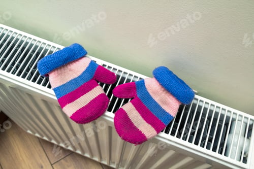 Preview: Children's warm hand knitted striped woolen gloves drying on hea