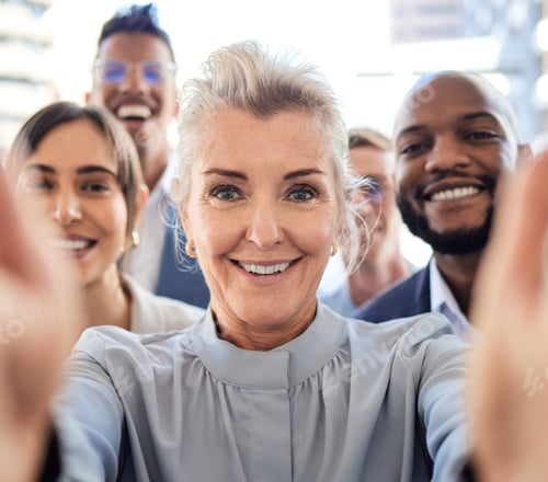 Preview: Portrait of a group of businesspeople taking selfies together in an office