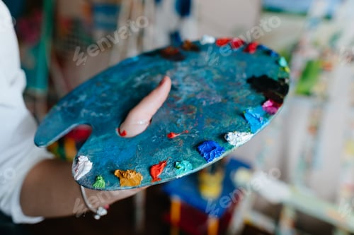 Preview: Artist Holding Palette With Colorful Paint Blobs