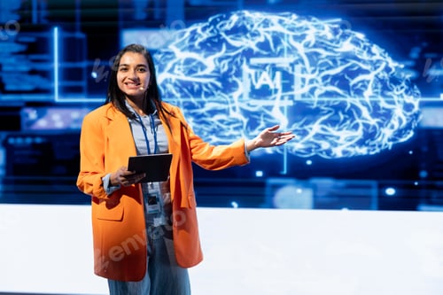 Preview: Happy presenter talking at AI summit using mic and tablet