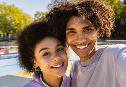 Preview: Interracial young couple dating outdoors, colored and modern urban background