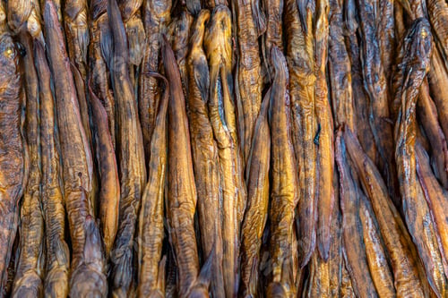 Preview: Various dried fish arranged neatly on display, showcasing their texture and color.