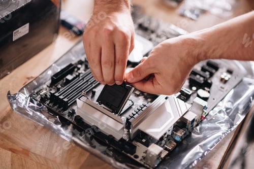 Preview: Closeup shot of hands of a technician repairing the pc