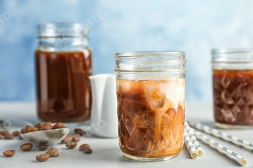 Preview: Jar with cold brew coffee and milk on table